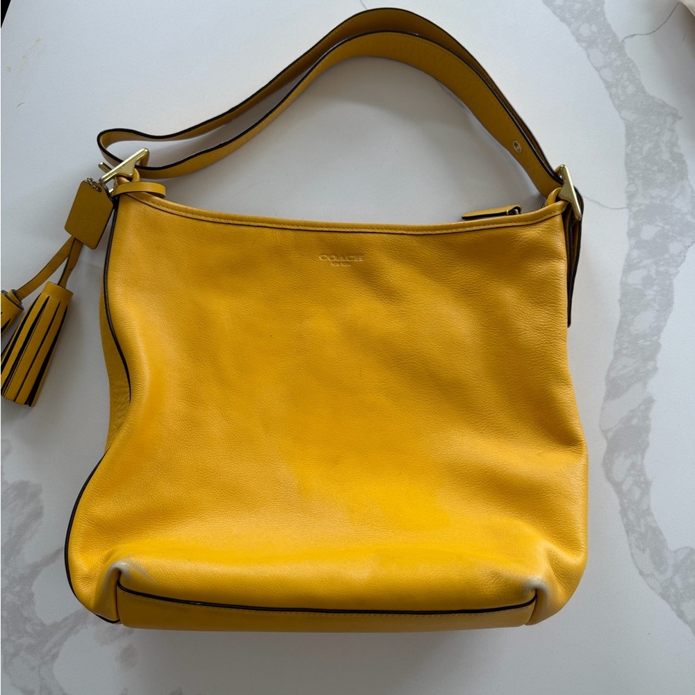 Coach duffle bag is identified as the Legacy